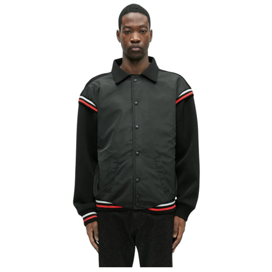 Man wearing a black jacket with red and white stripes on a white background