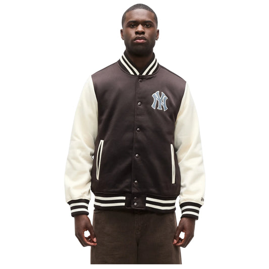 Man wearing a brown and white varsity jacket with a logo on a white background