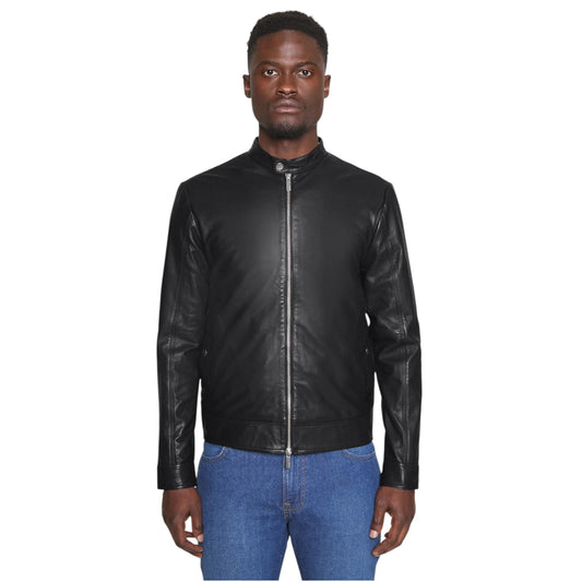 Man wearing a black leather jacket and blue jeans on a white background